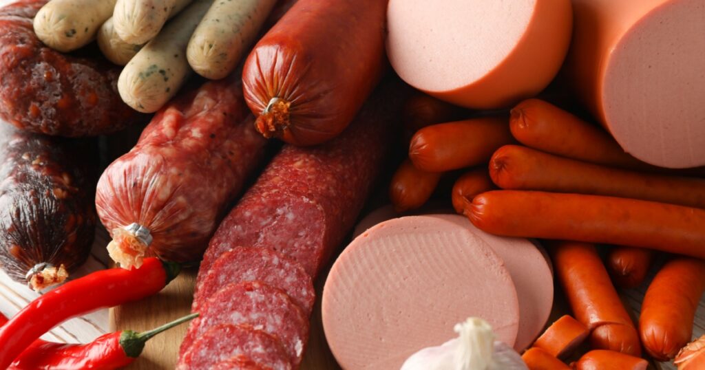 Sausage and spice on wooden background, close up