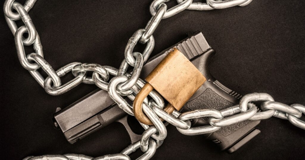 A chained up handgun kept safe from those who are a danger to society.