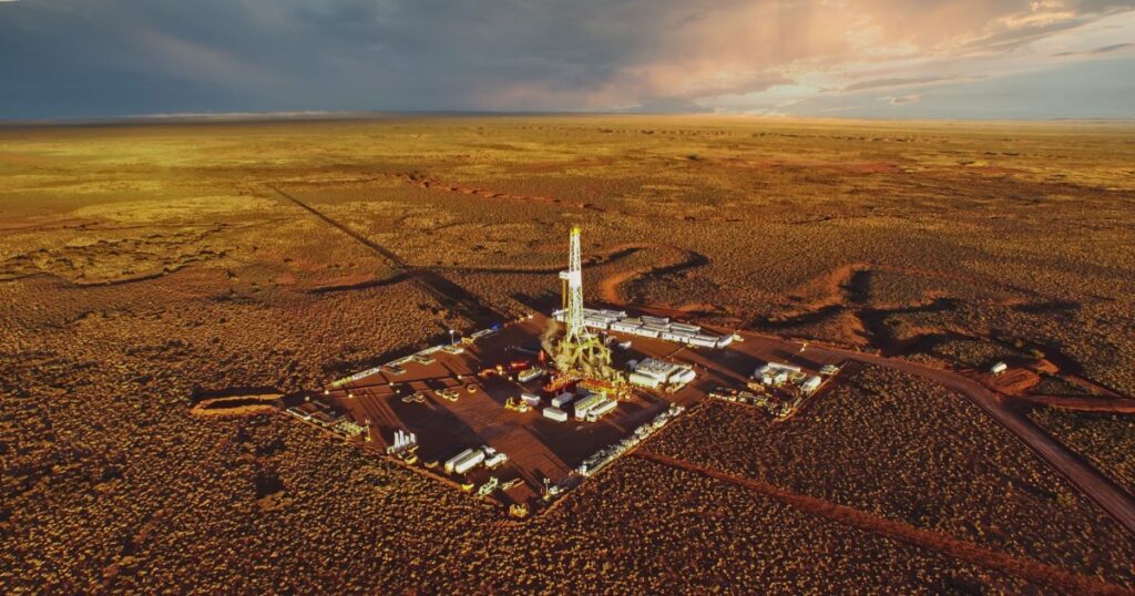 Aerial photo of hydraulic fracturing equipment at sunset. (FRACKING)