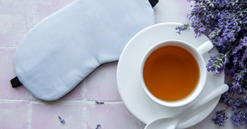 Healthy sleep concept. Lavender bouquet, lavender tea and sleep mask