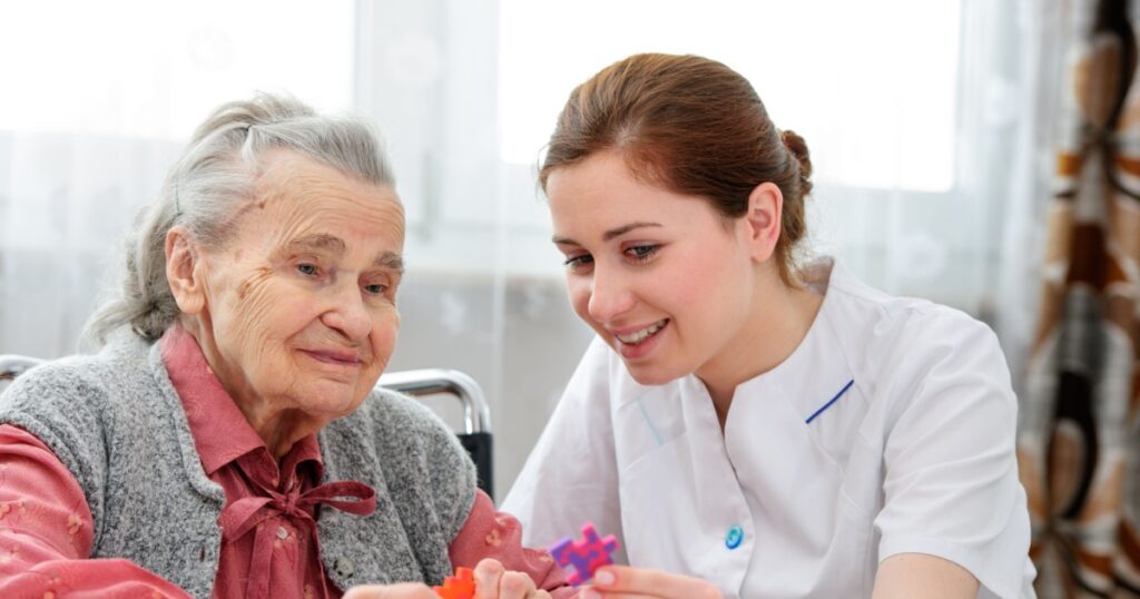 Elder care nurse playing jigsaw