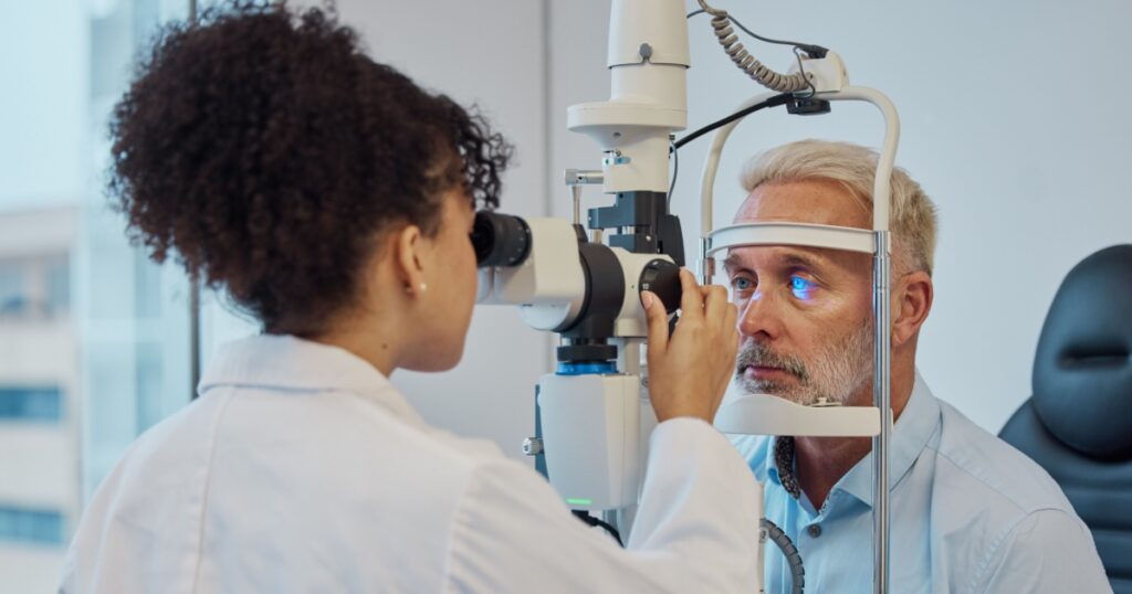Vision, eye exam and healthcare with a doctor woman or optometrist testing the eyes of a man patient in a clinic. Hospital, medical or consulting with a female eyesight specialist and senior male