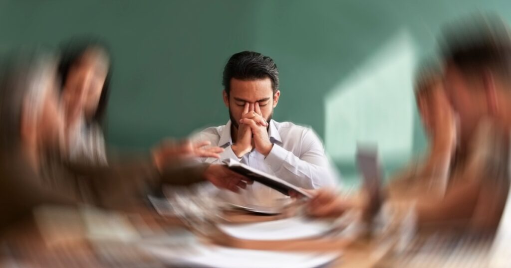 Stress, migraine and motion blur with a business man in a meeting feeling frustrated, tired or overworked. Mental health, anxiety and headache with an exhausted male employee suffering from fatigue
