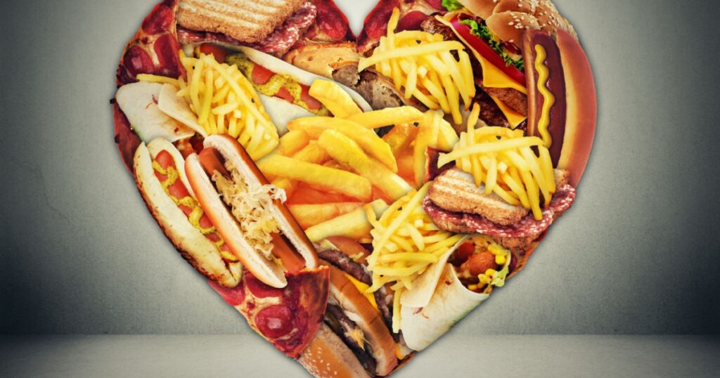 Heart health and bad diet stroke risk concept. Heart shaped of fast junk fatty food