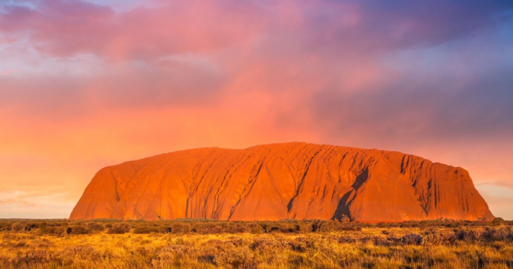 ULURU, AUSTRALIA - CIRCA AUGUST 2016: Uluru at sunset under colorful clouds,Uluru-Kata Tjuta National Park, Northern Territory, Australia