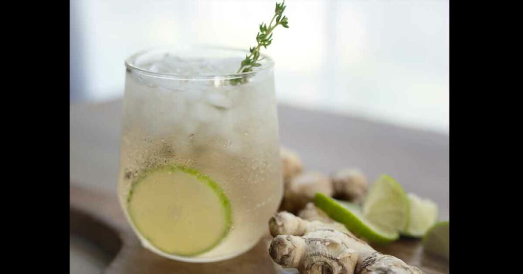 Ginger ale with fresh lime and thyme garnish