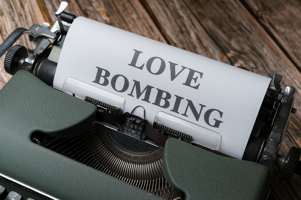 type writer with paper that says 'love bombing' 
