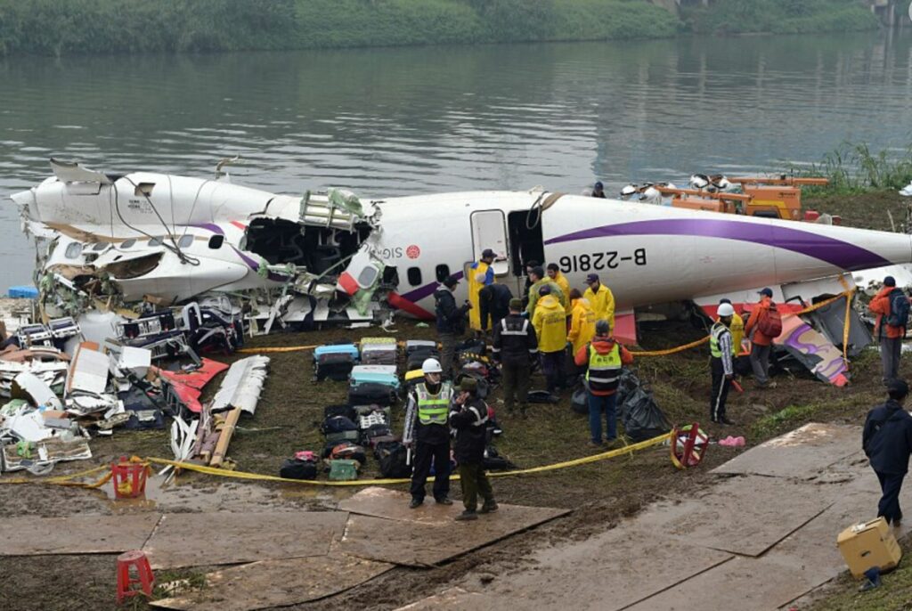 Plane crash in river, the result of a pilot error. Safety and rescue workers scattered among the remains. 