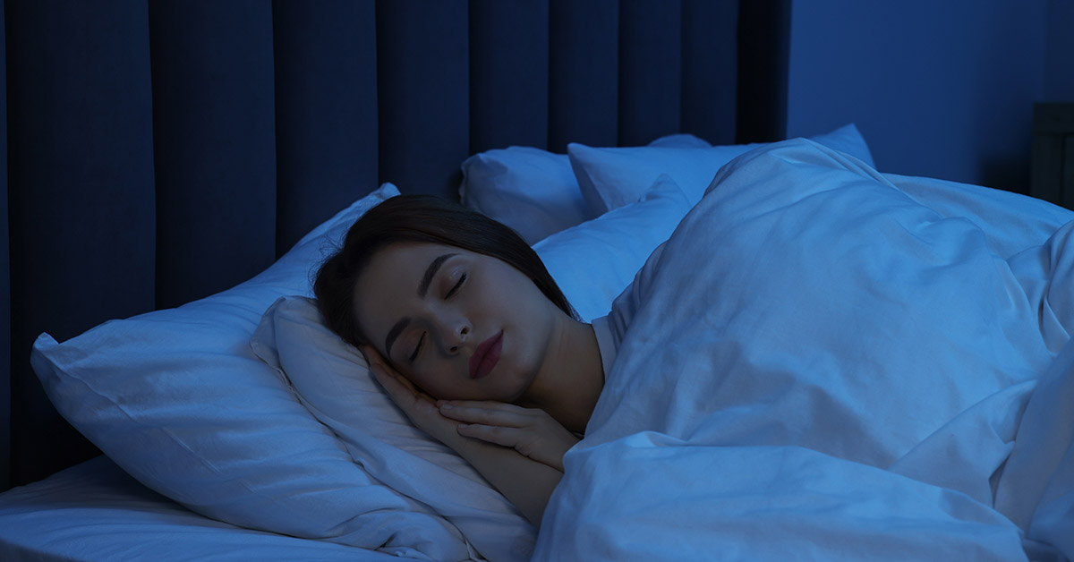 young woman sleeping in bed