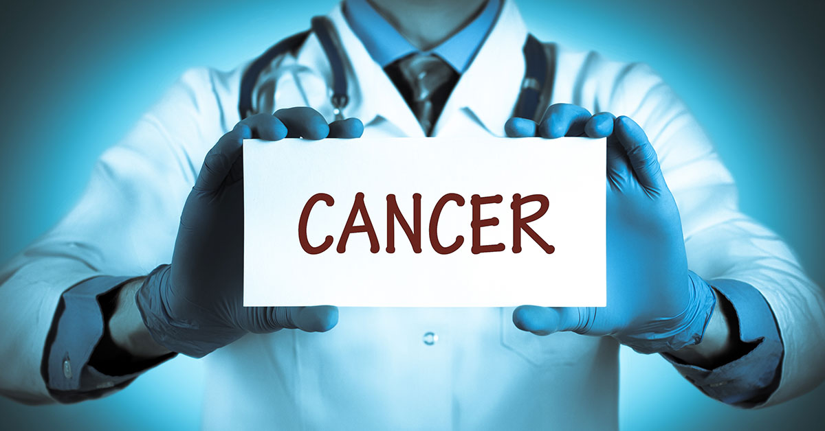 Doctor holding sign with "cancer" written on it
