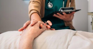 Son’s Tragic Last Words to His Mother Before Secretly Traveling to a Swiss Clinic to End His Life physician holding hands with someone laying down. Death concept. assisted dying concept