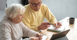 elderly couple sitting a table