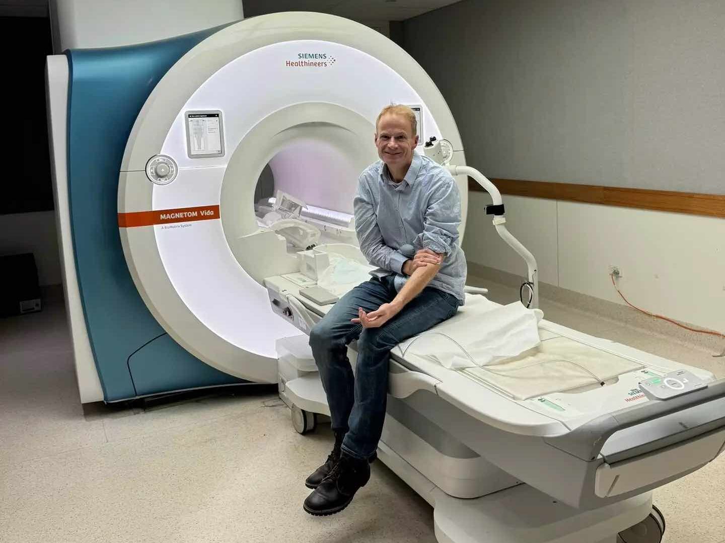 Richard Scolyer sitting near  MRI machine 