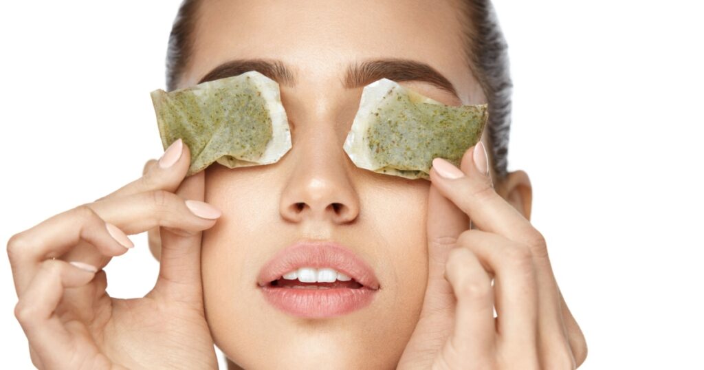 Eye Skin Care. Beautiful Woman With Green Tea Bag Under Eyes