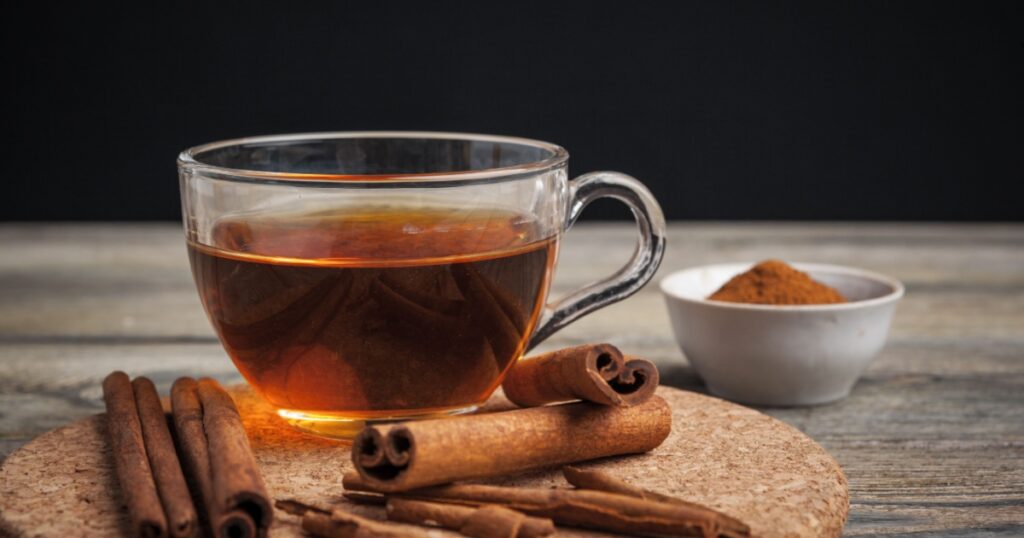aromatic hot cinnamon tea on wooden table