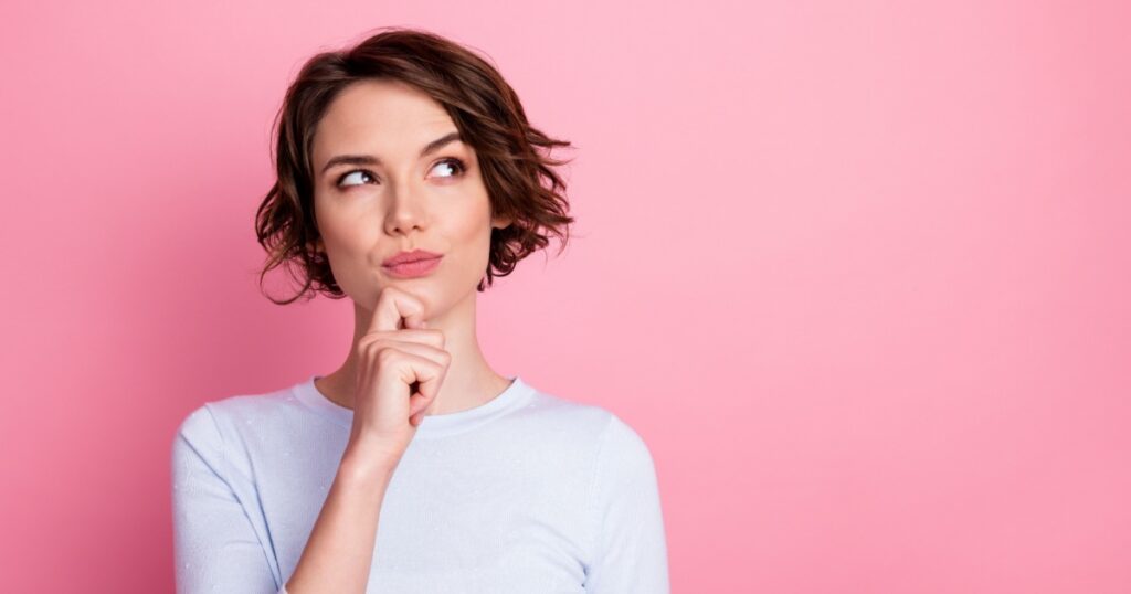 Focused smart girl look copyspace touch hand chin think decide wear pullover isolated pastel color background