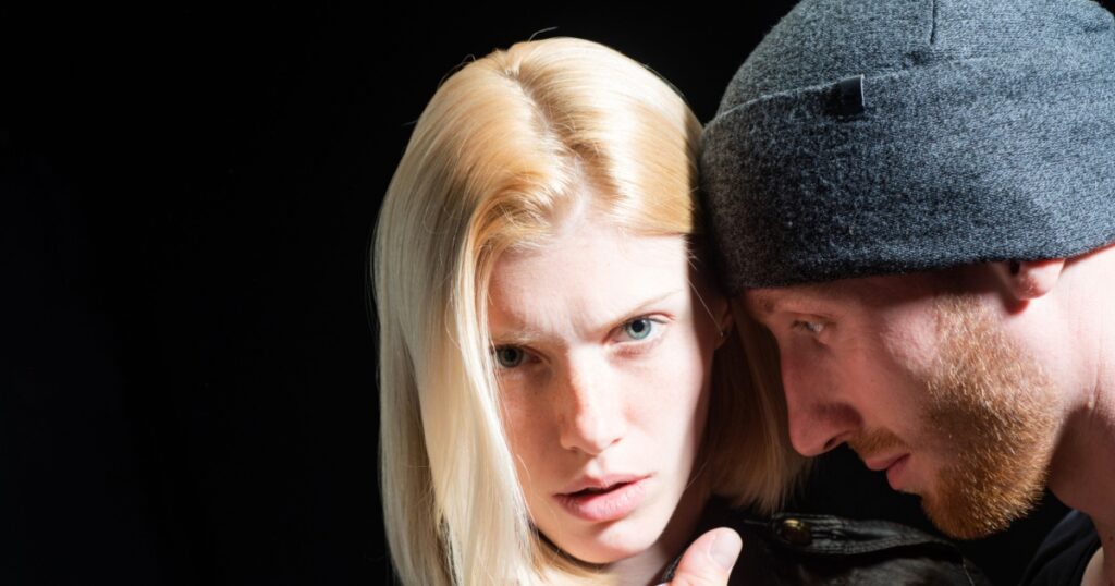Bad boyfriend. Close up of serious woman and man. Young couple in love have conflict. Young people isolated on black, each other. Family conflict, love break. Couple face, married problem.