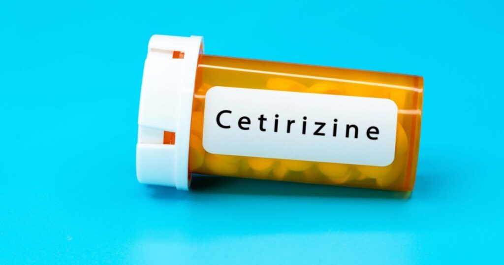 Cetirizine Medical vial with pills. Medical pills in orange Plastic Prescription. most popular medicine