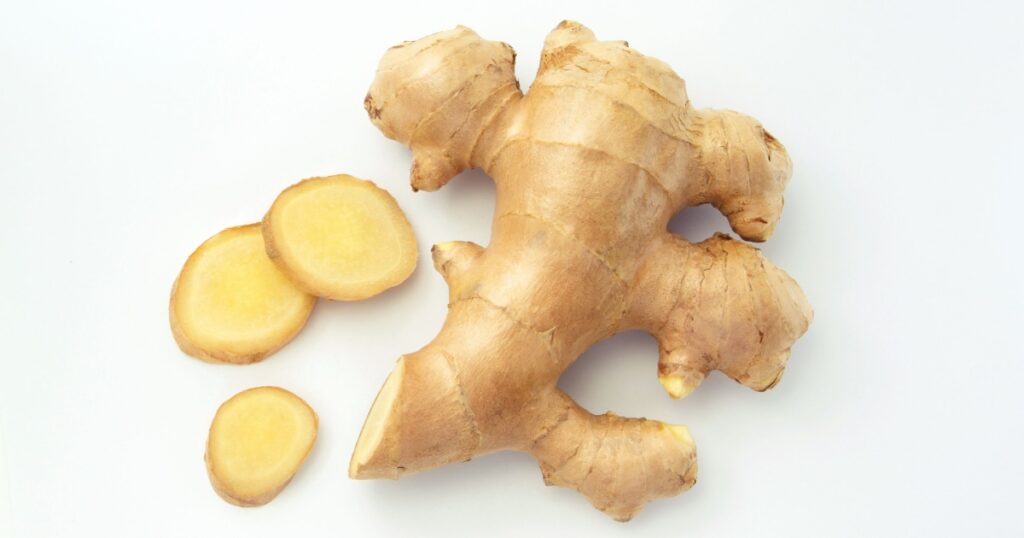 Ginger root with sliced on white paper background , top view , flat lay.
