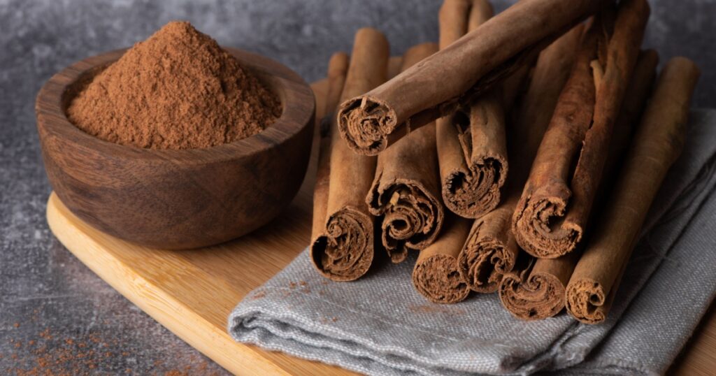 Cinnamon sticks on a wooden background. Cinnamon spice in a spoon and bowl. Ceylon cinnamon.