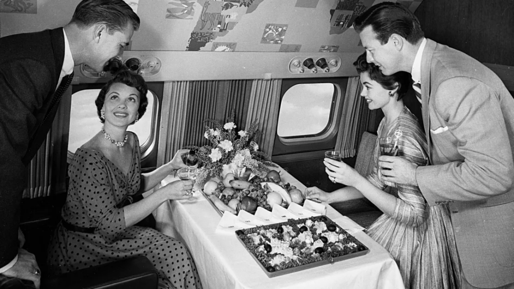 Travelers are served a buffet on board a Lockheed Super Constellation while flying with former American airline Trans World Airlines (TWA) in 1955