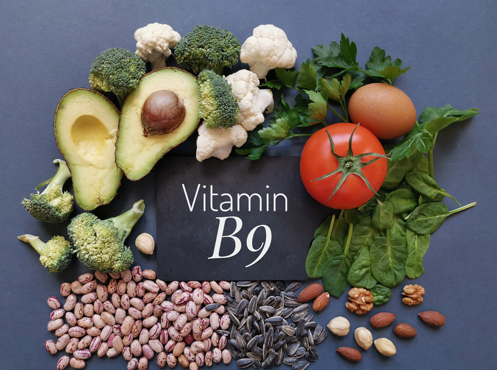 Food rich in folic acid or vitamin B9. Natural food sources of folic acid: avocado, cauliflower, broccoli, eggs, tomato, spinach, beans, nuts, parsley. Various food ingredients with Vitamin B9 letters