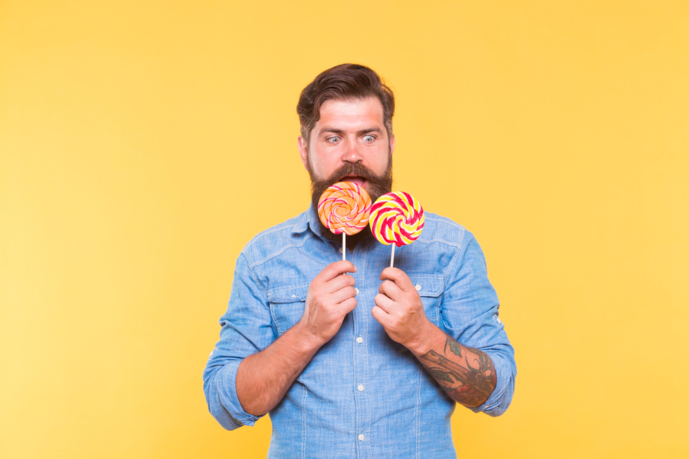 Dont let hunger happen to you. Surprised hipster look at lollipops. Enjoying candy snack. Unhealthy food and snacking. Diet and dieting. Sweet snack. Dessert. Candy shop. Double your pleasure.
