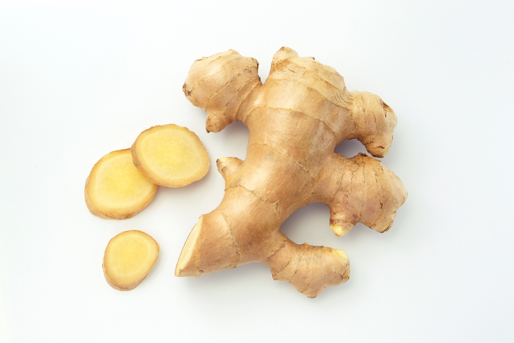 Ginger root with sliced on white paper background , top view , flat lay.