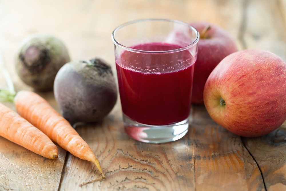 Glass of fresh beetroot, apple and carrot juice
