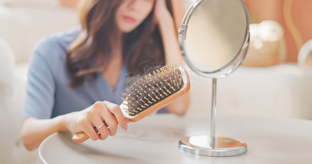 asian girl worry about hair loss - with the comb