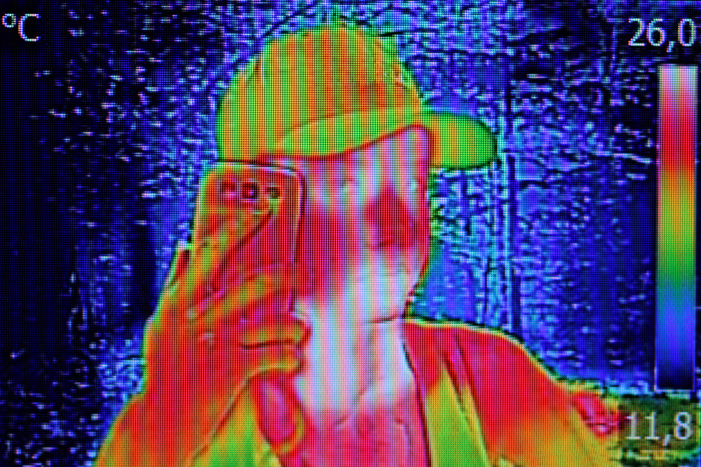 Infrared thermography image showing the heat emission when Young girl used smartphone or cell phone
