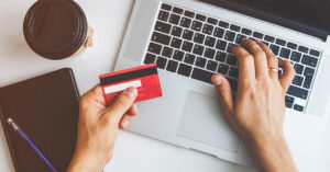 person using laptop to purchase or do online banking, paying bills