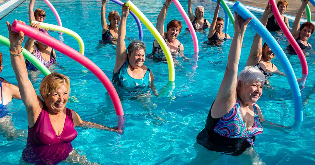 Elderly women enjoying aqua aerobics class