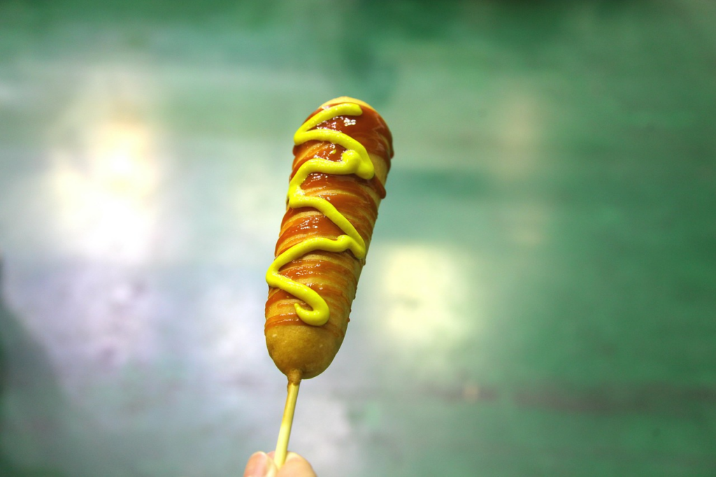Corn dog with mustard and ketchup