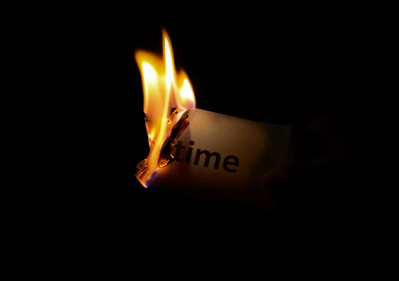 Burning a page with the word time on it
