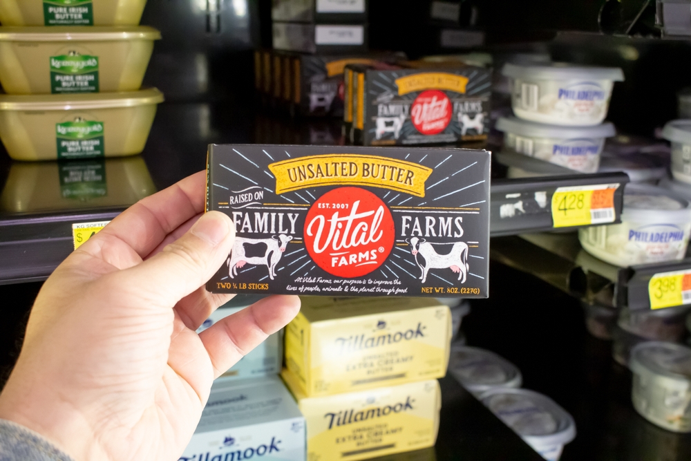 Los Angeles, California, United States - 02-01-2023: A view of a hand holding a package of Vital Farms unsalted butter, on display at a local grocery store.