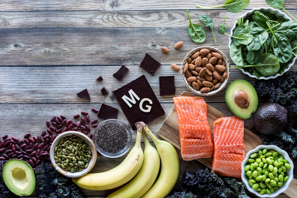 An assortment of food high in magnesium with the element symbol MG.
