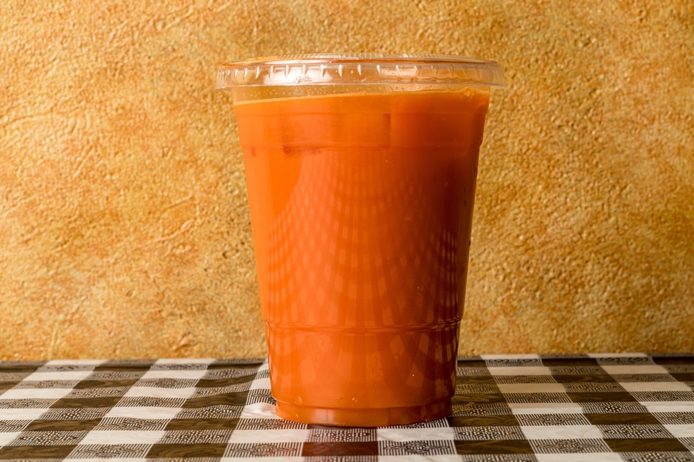 Carrot juice in a plastic cup
