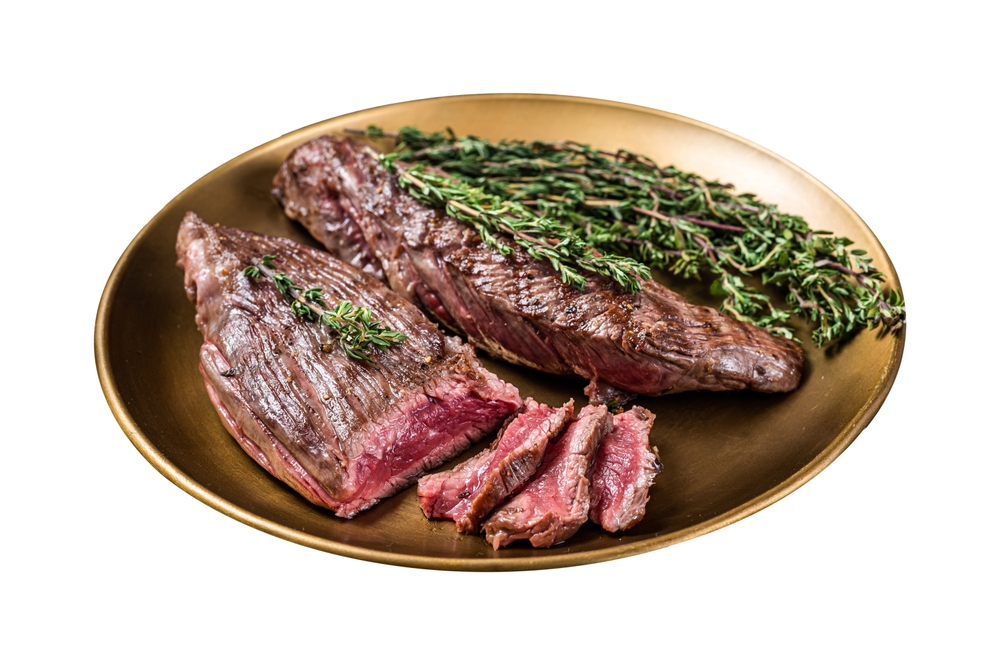 BBQ grilled Bavette Bavet beef meat steak with herbs on a plate. Isolated on white background