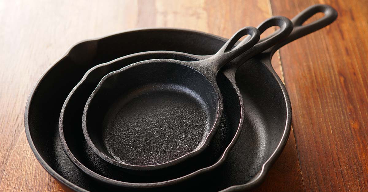 various sized cast iron pans placed inside each other