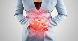 Certain Dietary Habits May Be Behind Colon Cancer Rise in Young People, Experts Theorize person holding abdomen. Colon health concept