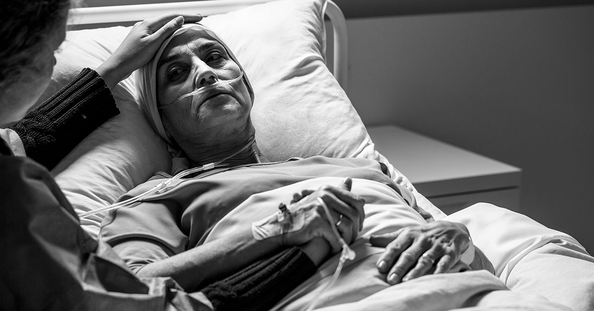 black and white image of patient in hospital bed. end of life, deathbed concept