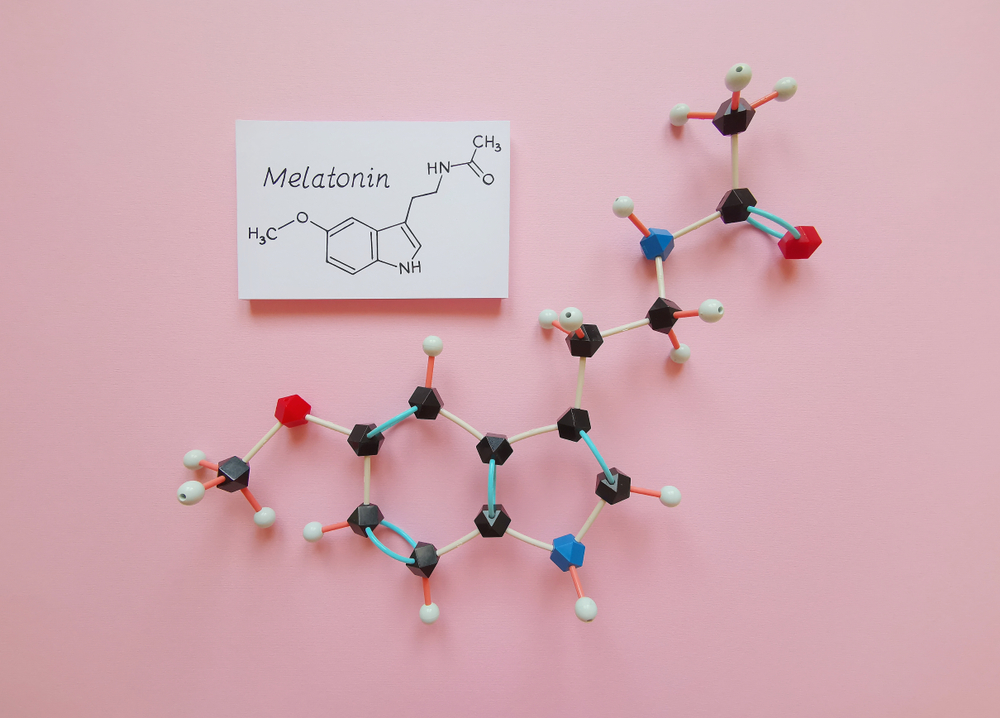 Molecular structure model and structural chemical formula of melatonin molecule. Melatonin is a hormone that regulates the sleep–wake cycle. Black=C, red=O, blue=N, white=H.
