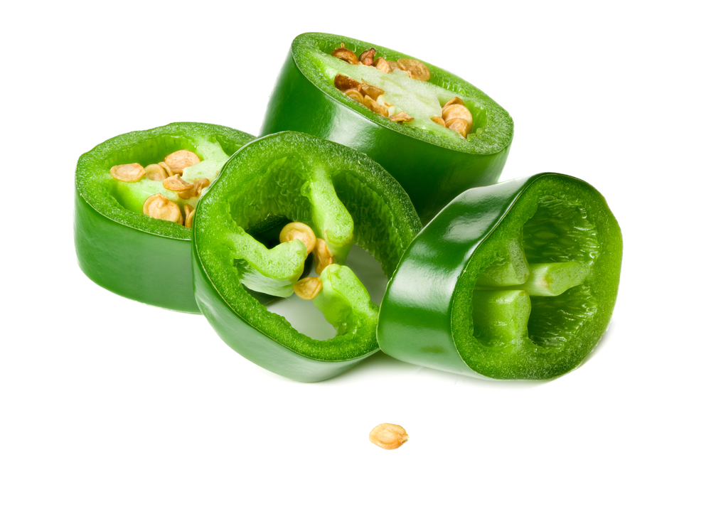 sliced jalapeno peppers isolated on white background. Green chili pepper. Capsicum annuum.