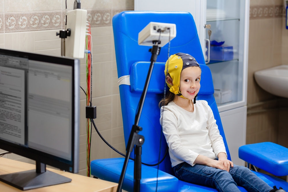 The study of a girl reveals diseases of the neurological and mental spectrum, while the medical staff conducts an EEG electroencephalogram in the hospital laboratory.