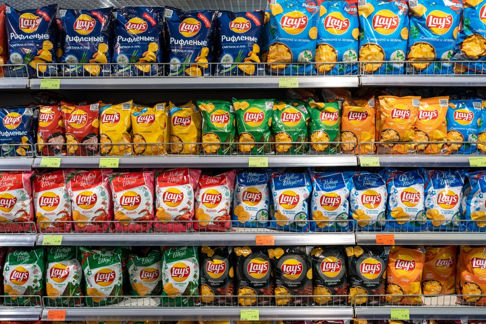 Various choice flavoured of lay's potato chips for sale in grocery store. Lay's has been owned by PepsiCo through Frito-Lay since 1965. Minsk, Belarus, 2023