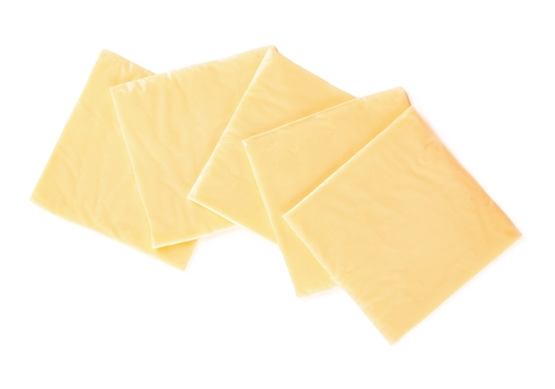 Slices of tasty processed cheese on white background
