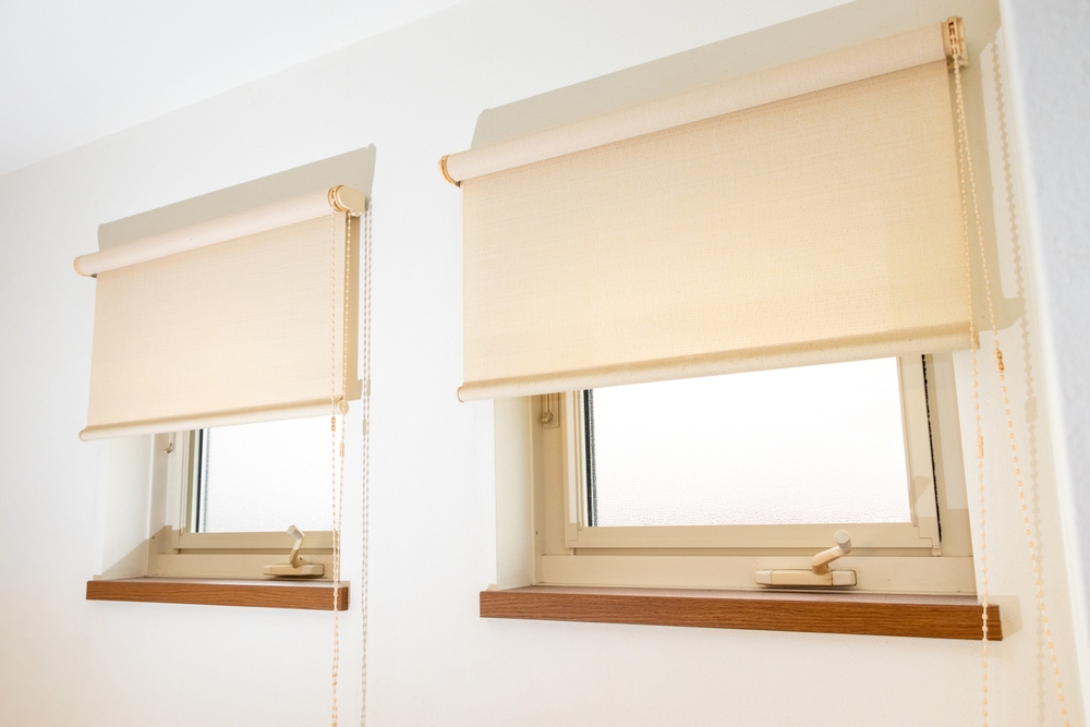 Two small square windows with rolling screens