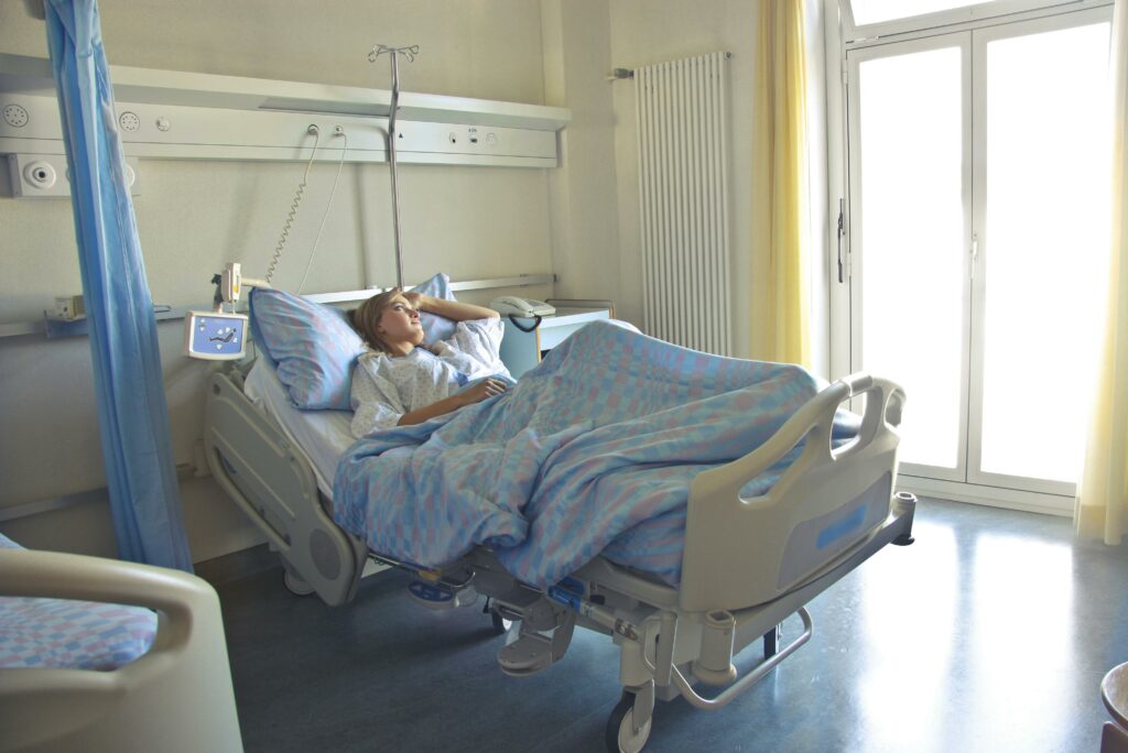 Photo of Woman Lying in Hospital Bed 