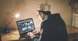 Seventeen “Conspiracy Theories” That Turned Out To Be Completely True man in tinfoil hat using laptop. conspiracy theory concept